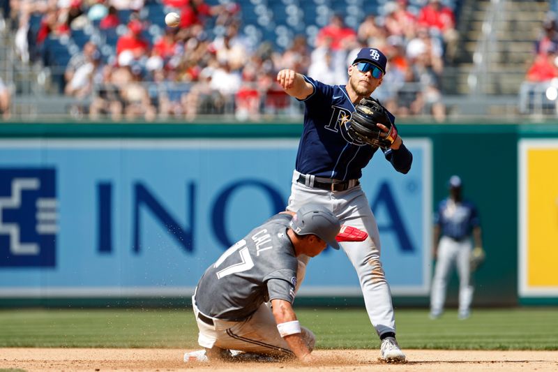 Apr 5, 2023; Washington, District of Columbia, USA; Tampa Bay Rays third baseman Taylor Walls (6) turns a double play at second base ahead of the slide of Washington Nationals left fielder Alex Call (17) during the fifth inning at Nationals Park. Mandatory Credit: Geoff Burke-USA TODAY Sports