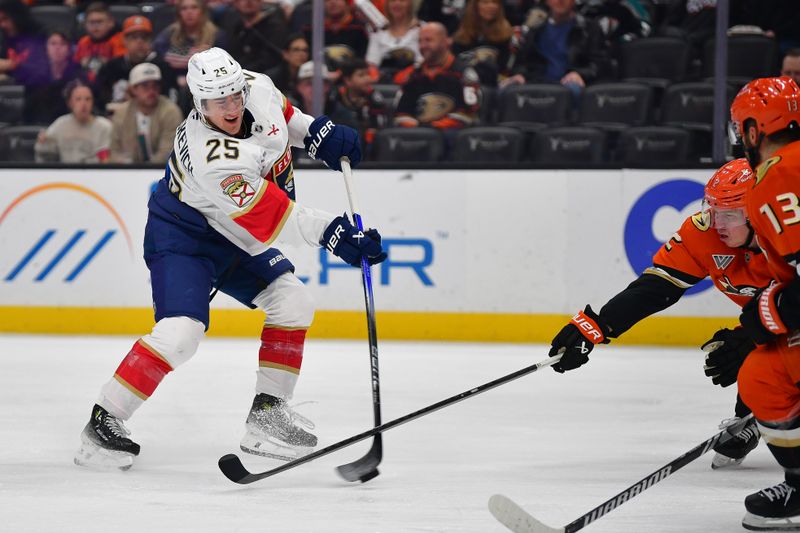 Jan 21, 2025; Anaheim, California, USA; Florida Panthers right wing Mackie Samoskevich (25) shoots on goal against Anaheim Ducks defenseman Jackson LaCombe (2) and center Robby Fabbri (13) during the first period at Honda Center. Mandatory Credit: Gary A. Vasquez-Imagn Images