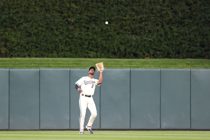 Oct 11, 2023; Minneapolis, Minnesota, USA; Minnesota Twins center fielder Michael A. Taylor (2) catches a fly ball for an out in the first inning against the Houston Astros  during game four of the ALDS for the 2023 MLB playoffs at Target Field. Mandatory Credit: Jesse Johnson-USA TODAY Sports