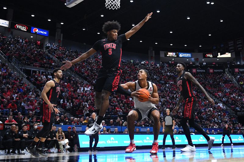 Jan 6, 2024; San Diego, California, USA; UNLV Rebels forward Rob Whaley Jr. (5) defends San Diego State Aztecs forward Jaedon LeDee (13) during the second half at Viejas Arena. Mandatory Credit: Orlando Ramirez-USA TODAY Sports