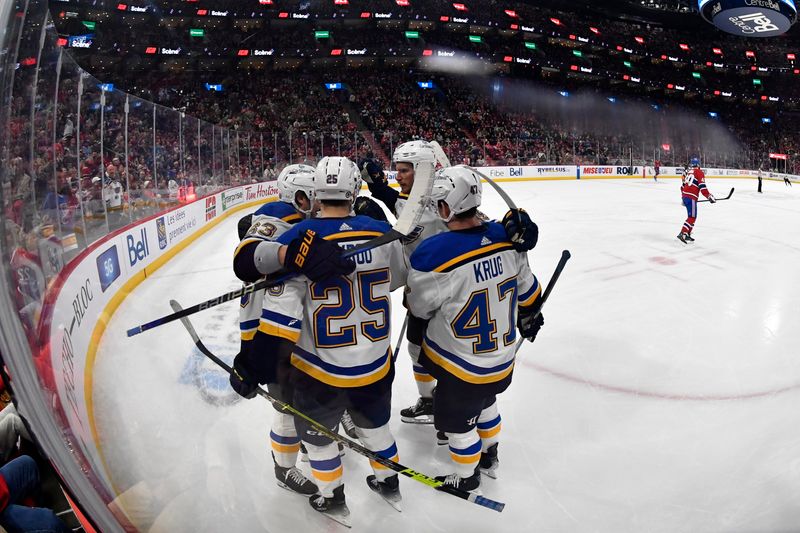 Feb 11, 2024; Montreal, Quebec, CAN; St.Louis Blues forward Jordan Kyrou (25) celebrates with teammates after scoring a goal against the Montreal Canadiens during the first period at the Bell Centre. Mandatory Credit: Eric Bolte-USA TODAY Sports