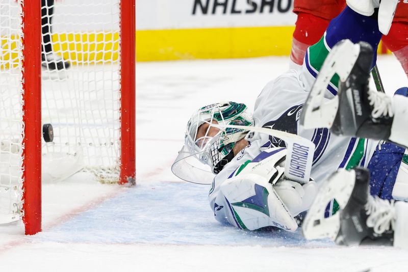 Dec 1, 2024; Detroit, Michigan, USA;  Vancouver Canucks goaltender Kevin Lankinen (32) looks back to see the puck in the net in the second period against the Detroit Red Wings at Little Caesars Arena. Mandatory Credit: Rick Osentoski-Imagn Images