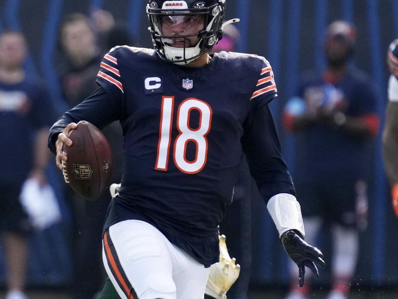 Chicago Bears' Caleb Williams runs past Green Bay Packers' Edgerrin Cooper during the first half of an NFL football game Sunday, Nov. 17, 2024, in Chicago. (AP Photo/Nam Y. Huh)