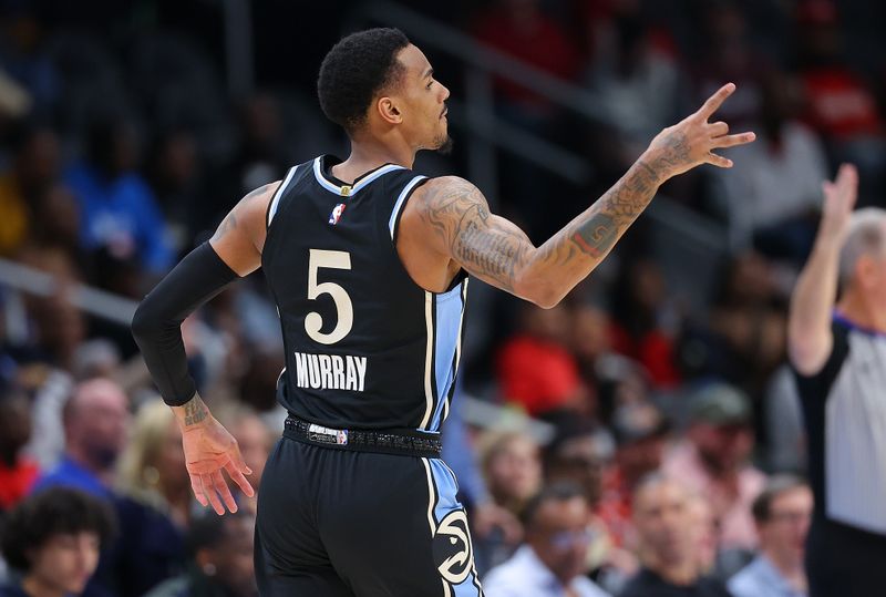 ATLANTA, GEORGIA - MARCH 30:  Dejounte Murray #5 of the Atlanta Hawks reacts after hitting a three-point basket against the Milwaukee Bucks during the first quarter at State Farm Arena on March 30, 2024 in Atlanta, Georgia.  NOTE TO USER: User expressly acknowledges and agrees that, by downloading and/or using this photograph, user is consenting to the terms and conditions of the Getty Images License Agreement.  (Photo by Kevin C. Cox/Getty Images)