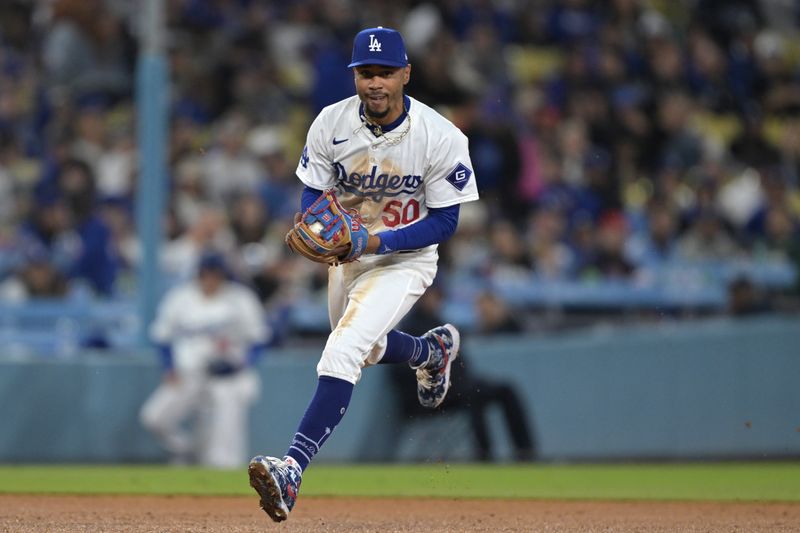 Apr 2, 2024; Los Angeles, California, USA;  Los Angeles Dodgers shortstop Mookie Betts (50) throws San Francisco Giants shortstop Nick Ahmed (16) out at first in the seventh inning at Dodger Stadium. Mandatory Credit: Jayne Kamin-Oncea-USA TODAY Sports