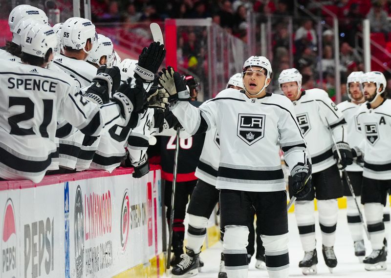 Jan 15, 2024; Raleigh, North Carolina, USA; Los Angeles Kings left wing Trevor Moore (12) celebrates his goal against the Carolina Hurricanes during the first period at PNC Arena. Mandatory Credit: James Guillory-USA TODAY Sports