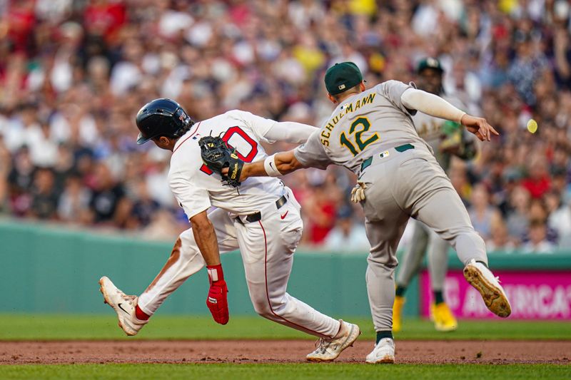 Jul 11, 2024; Boston, Massachusetts, USA; Boston Red Sox second baseman David Hamilton (70) tagged out by Oakland Athletics shortstop Max Schuemann (12) in the second inning at Fenway Park. Mandatory Credit: David Butler II-USA TODAY Sports