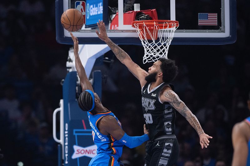 OKLAHOMA CITY, OKLAHOMA - APRIL 10: Shai Gilgeous-Alexander #2 of the Oklahoma City Thunder puts up a shot over Julian Champagnie #30 of the San Antonio Spurs during the first half at Paycom Center on April 10, 2024 in Oklahoma City, Oklahoma. NOTE TO USER: User expressly acknowledges and agrees that, by downloading and or using this Photograph, user is consenting to the terms and conditions of the Getty Images License Agreement. (Photo by Joshua Gateley/Getty Images)