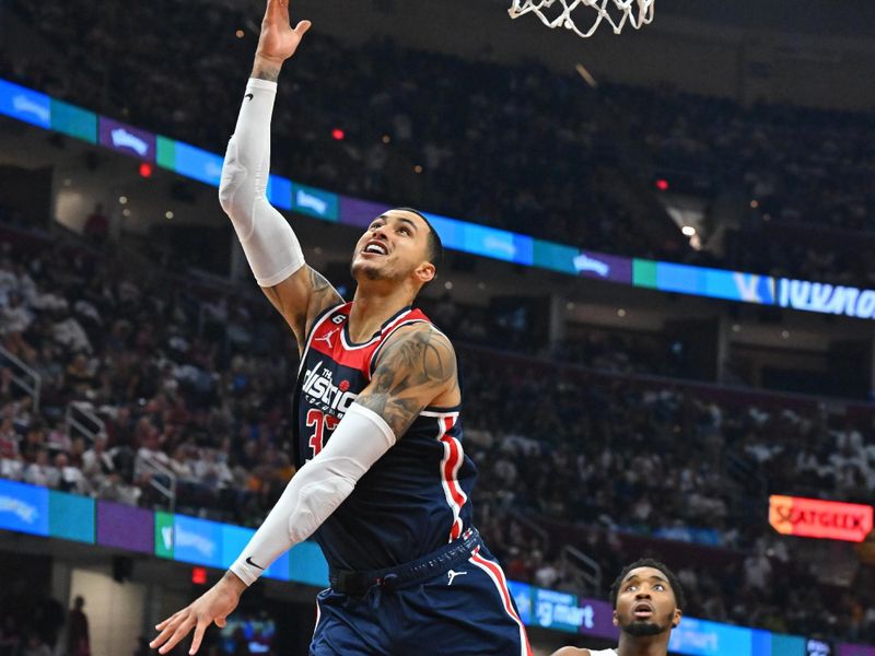 CLEVELAND, OHIO - OCTOBER 23: Kyle Kuzma #33 of the Washington Wizards shoots ahead of Donovan Mitchell #45 of the Cleveland Cavaliers during the third quarter at Rocket Mortgage Fieldhouse on October 23, 2022 in Cleveland, Ohio. The Cavaliers defeated the Wizards 117-107 in overtime. NOTE TO USER: User expressly acknowledges and agrees that, by downloading and or using this photograph, User is consenting to the terms and conditions of the Getty Images License Agreement. (Photo by Jason Miller/Getty Images)