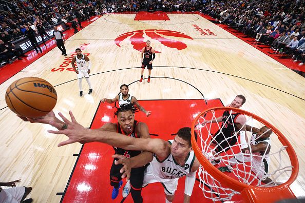 TORONTO, CANADA - NOVEMBER 15: Scottie Barnes #4 of the Toronto Raptors drives to the net against Brook Lopez #11 of the Milwaukee Bucks during the second half of their NBA game at Scotiabank Arena on November 15, 2023 in Toronto, Canada. NOTE TO USER: User expressly acknowledges and agrees that, by downloading and or using this photograph, User is consenting to the terms and conditions of the Getty Images License Agreement. (Photo by Cole Burston/Getty Images)