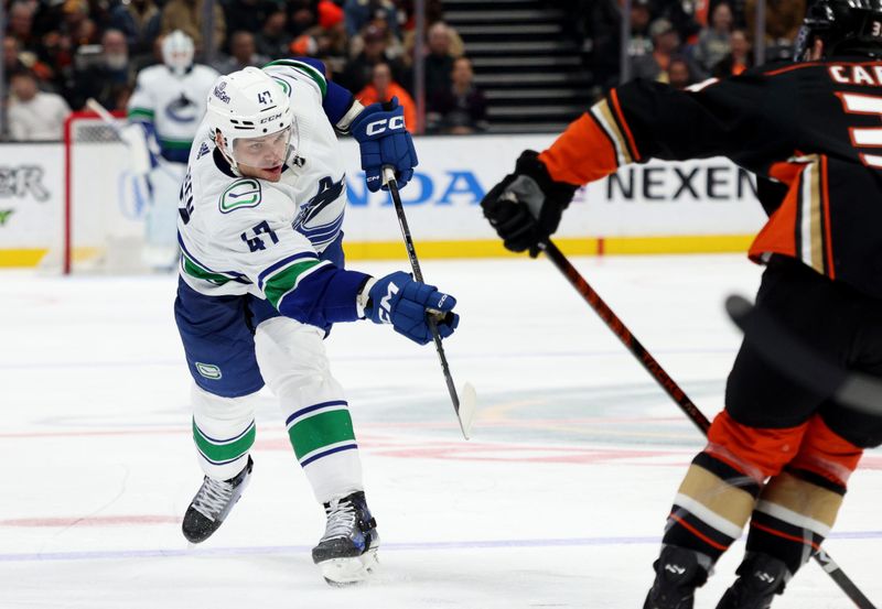 Mar 3, 2024; Anaheim, California, USA; Vancouver Canucks defenseman Noah Juulsen (47) shoots during the third period against the Anaheim Ducks at Honda Center. Mandatory Credit: Jason Parkhurst-USA TODAY Sports