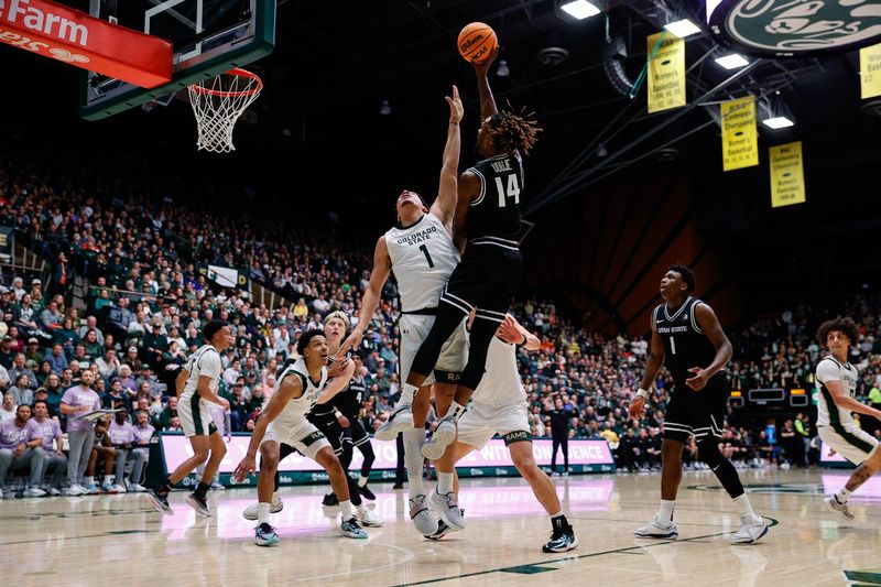 Feb 17, 2024; Fort Collins, Colorado, USA; Utah State Aggies guard Josh Uduje (14) attempts a shot as Colorado State Rams forward Joel Scott (1) defends in the first half at Moby Arena. Mandatory Credit: Isaiah J. Downing-USA TODAY Sports