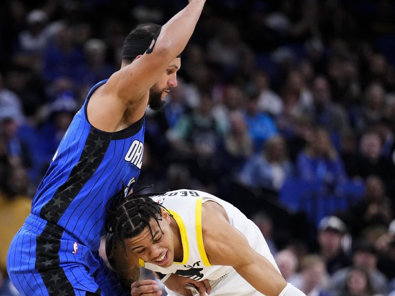 ORLANDO, FLORIDA - FEBRUARY 29: Keyonte George #3 of the Utah Jazz dribbles the ball against Jalen Suggs #4 of the Orlando Magic during the fourth quarterat Kia Center on February 29, 2024 in Orlando, Florida. NOTE TO USER: User expressly acknowledges and agrees that, by downloading and or using this photograph, user is consenting to the terms and conditions of the Getty Images License Agreement. (Photo by Rich Storry/Getty Images)