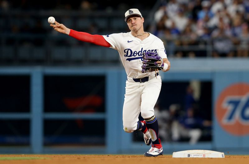 Jul 4, 2024; Los Angeles, California, USA; Los Angeles Dodgers third baseman Enrique Hernandez (8) throws to first for an out during the ninth inning against the Arizona Diamondbacks at Dodger Stadium. Mandatory Credit: Jason Parkhurst-USA TODAY Sports