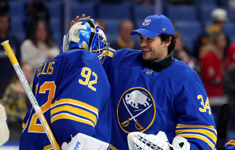 Oct 22, 2025; Buffalo, New York, USA;  Buffalo Sabres goaltender Colten Ellis (92) celebrates his first NHL win against the Detroit Red Wings with goaltender Alex Lyon (34) at KeyBank Center. Mandatory Credit: Timothy T. Ludwig-Imagn Images
