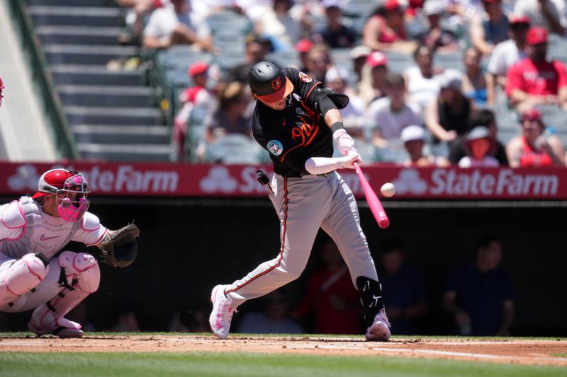 May 11, 2025; Anaheim, California, USA; Baltimore Orioles designated hitter Adley Rutschman (35) hits a RBI triple in the first inning against the Los Angeles Angels at Angel Stadium. Mandatory Credit: Kirby Lee-Imagn Images