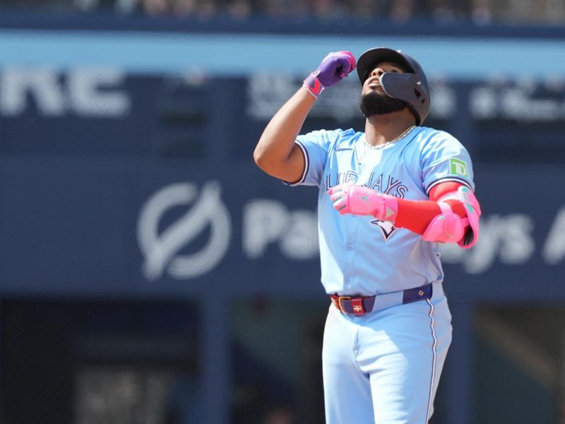 Aug 25, 2024; Toronto, Ontario, CAN; Toronto Blue Jays first base Vladimir Guerrero Jr. (27) celebrates hitting an RBI double against the Los Angeles Angels during the fifth inning at Rogers Centre. Mandatory Credit: Nick Turchiaro-USA TODAY Sports