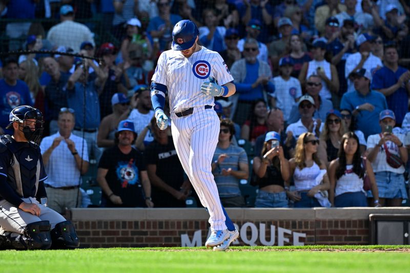 Sep 14, 2025; Chicago, Illinois, USA;  Chicago Cubs outfielder Ian Happ (8) crosses home plate after hitting a home run against the Tampa Bay Rays during the sixth inning at Wrigley Field. Mandatory Credit: Matt Marton-Imagn Images