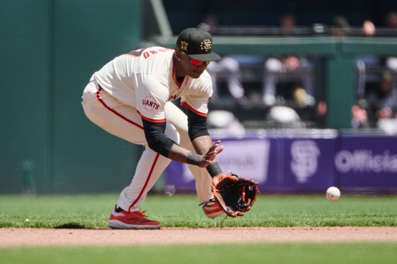 May 19, 2024; San Francisco, California, USA; San Francisco Giants infielder Marco Luciano (37) fields a ground ball against the Colorado Rockies during the fourth inning at Oracle Park. Mandatory Credit: Robert Edwards-USA TODAY Sports