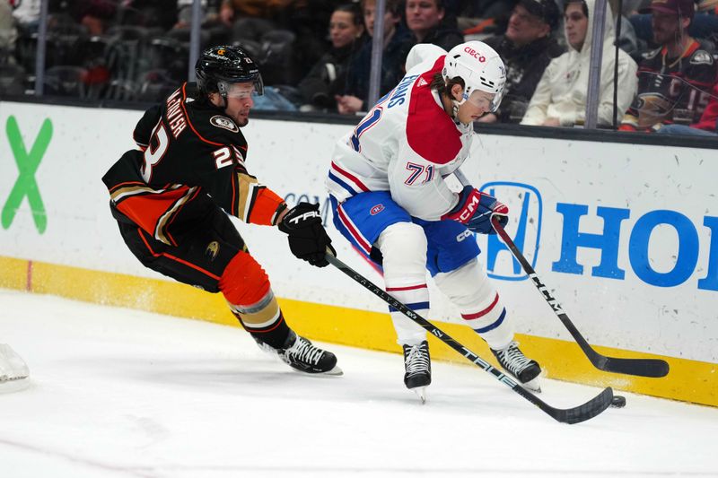 Nov 22, 2023; Anaheim, California, USA; Montreal Canadiens center Jake Evans (71) and Anaheim Ducks center Mason McTavish (23) battle for the puck in the first period at Honda Center. Mandatory Credit: Kirby Lee-USA TODAY Sports