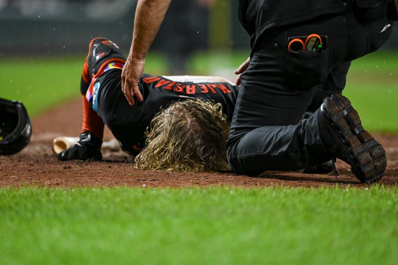 Jul 12, 2024; Baltimore, Maryland, USA;  Baltimore Orioles trainer Brain Ebal tends to  outfielder Heston Kjerstad (13) after being  hit by a pitch in the head during the ninth inning against the New York Yankees at Oriole Park at Camden Yards. Mandatory Credit: Tommy Gilligan-USA TODAY Sports