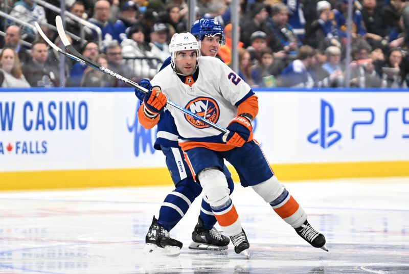 Feb 5, 2024; Toronto, Ontario, CAN;  New York Islanders forward Kyle Palmieri (21) skates past Toronto Maple Leafs forward Mitchell Marner (16) in the second period at Scotiabank Arena. Mandatory Credit: Dan Hamilton-USA TODAY Sports