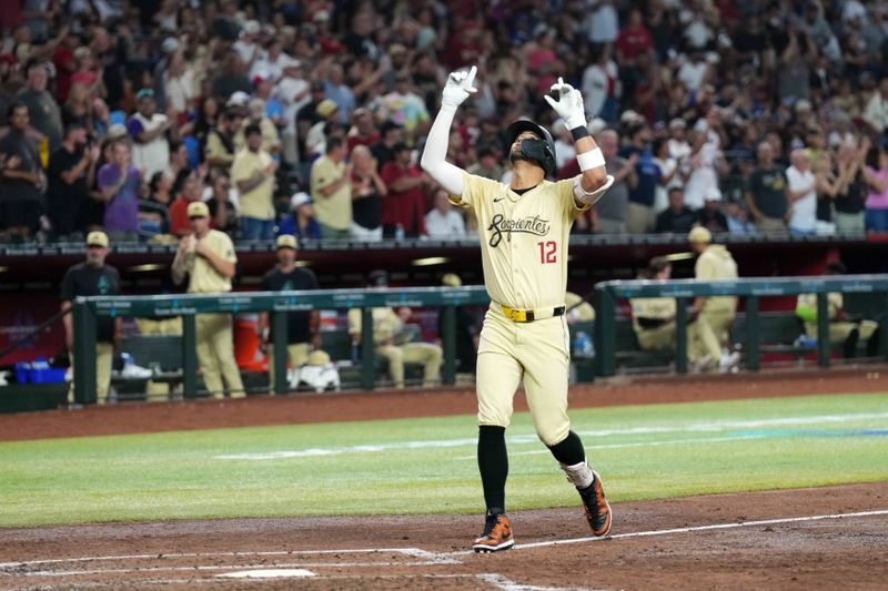 Aug 31, 2024; Phoenix, Arizona, USA; Arizona Diamondbacks outfielder Lourdes Gurriel Jr. (12) approaches home plate after hitting a solo home run against the Los Angeles Dodgers during the third inning at Chase Field. Mandatory Credit: Joe Camporeale-USA TODAY Sports