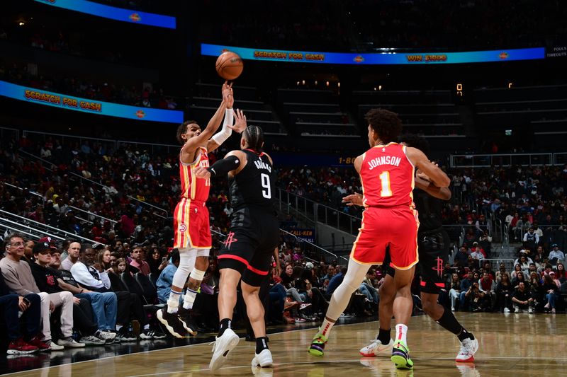 ATLANTA, GA - FEBRUARY 10: Trae Young #11 of the Atlanta Hawks shoots a three point basket against the Houston Rockets on February 10, 2024 at State Farm Arena in Atlanta, Georgia.  NOTE TO USER: User expressly acknowledges and agrees that, by downloading and/or using this Photograph, user is consenting to the terms and conditions of the Getty Images License Agreement. Mandatory Copyright Notice: Copyright 2024 NBAE (Photo by Scott Cunningham/NBAE via Getty Images)