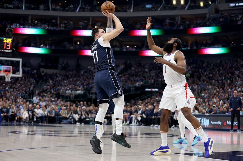 DALLAS, TEXAS - APRIL 28: Luka Doncic #77 of the Dallas Mavericks shoots while defended by James Harden #1 of the Los Angeles Clippers in the first half of game four of the Western Conference First Round Playoffs at American Airlines Center on April 28, 2024 in Dallas, Texas.  NOTE TO USER: User expressly acknowledges and agrees that, by downloading and or using this photograph, User is consenting to the terms and conditions of the Getty Images License Agreement. (Photo by Tim Warner/Getty Images)