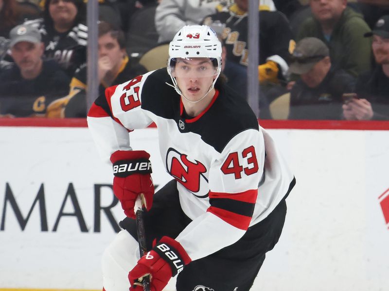 Jan 8, 2026; Pittsburgh, Pennsylvania, USA;  New Jersey Devils defenseman Luke Hughes (43) skates up ice with the puck against the Pittsburgh Penguins during the second period at PPG Paints Arena. Mandatory Credit: Charles LeClaire-Imagn Images