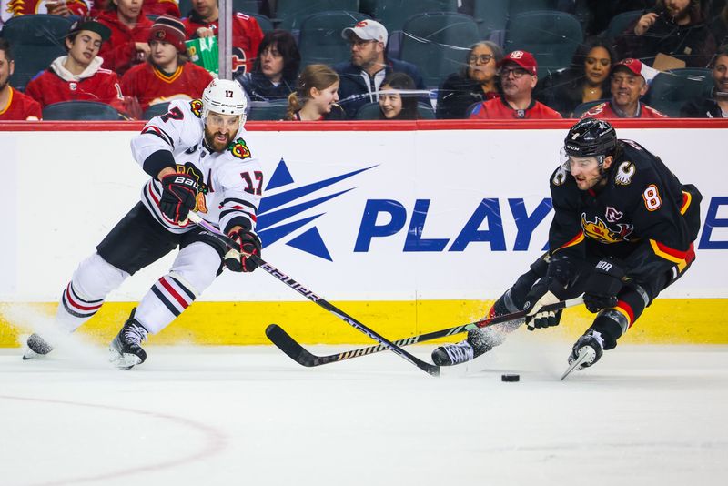 Jan 27, 2024; Calgary, Alberta, CAN; Chicago Blackhawks left wing Nick Foligno (17) and Calgary Flames defenseman Chris Tanev (8) battles for the puck during the second period at Scotiabank Saddledome. Mandatory Credit: Sergei Belski-USA TODAY Sports