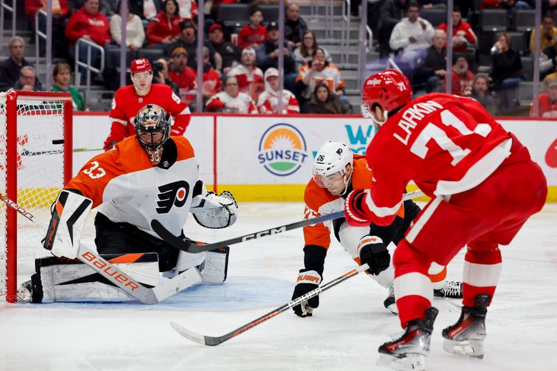 Jan 25, 2024; Detroit, Michigan, USA;  Detroit Red Wings center Dylan Larkin (71) scores a goal on Philadelphia Flyers goaltender Samuel Ersson (33) in the second period at Little Caesars Arena. Mandatory Credit: Rick Osentoski-USA TODAY Sports