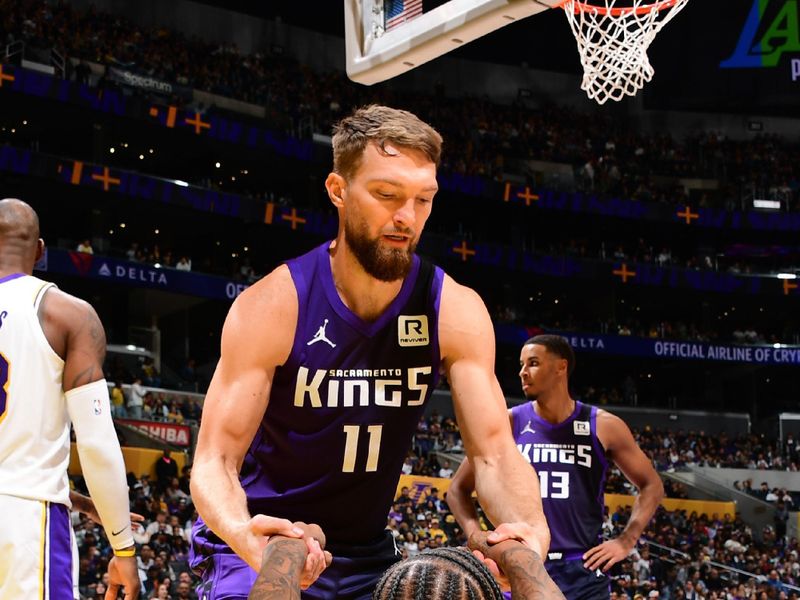 LOS ANGELES, CA - OCTOBER 26: Domantas Sabonis #11 helps up DeMar DeRozan #10 of the Sacramento Kings during the game against the Los Angeles Lakers on October 26, 2024 at Crypto.Com Arena in Los Angeles, California. NOTE TO USER: User expressly acknowledges and agrees that, by downloading and/or using this Photograph, user is consenting to the terms and conditions of the Getty Images License Agreement. Mandatory Copyright Notice: Copyright 2024 NBAE (Photo by Adam Pantozzi/NBAE via Getty Images)