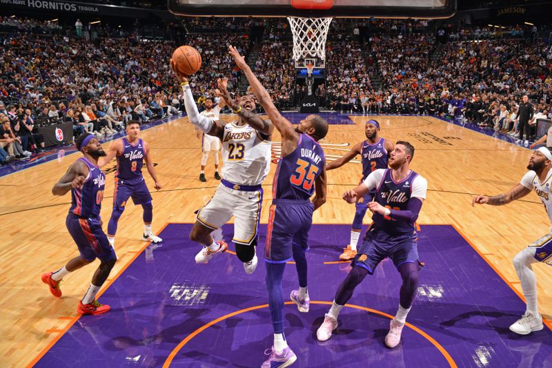 PHOENIX, AZ - FEBRUARY 25: LeBron James #23 of the Los Angeles Lakers drives to the basket during the game against the Phoenix Suns on February 25, 2024 at Footprint Center in Phoenix, Arizona. NOTE TO USER: User expressly acknowledges and agrees that, by downloading and or using this photograph, user is consenting to the terms and conditions of the Getty Images License Agreement. Mandatory Copyright Notice: Copyright 2024 NBAE (Photo by Barry Gossage/NBAE via Getty Images)