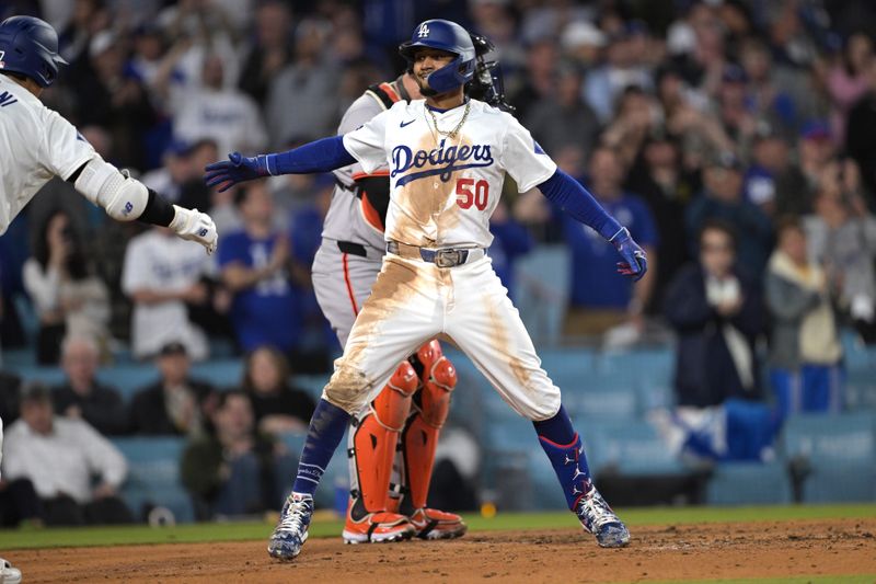 Apr 2, 2024; Los Angeles, California, USA; Los Angeles Dodgers shortstop Mookie Betts (50) is congratulated by designated hitter Shohei Ohtani (17) after hitting a solo home run for his 1500th career hit in the third inning against the San Francisco Giants at Dodger Stadium. Mandatory Credit: Jayne Kamin-Oncea-USA TODAY Sports