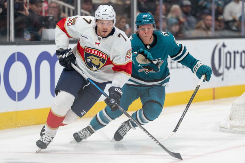 Nov 14, 2023; San Jose, California, USA; Florida Panthers defenseman Dmitry Kulikov (7) and San Jose Sharks left wing Fabian Zetterlund (20) chase after the puck during the second period at SAP Center at San Jose. Mandatory Credit: Stan Szeto-USA TODAY Sports