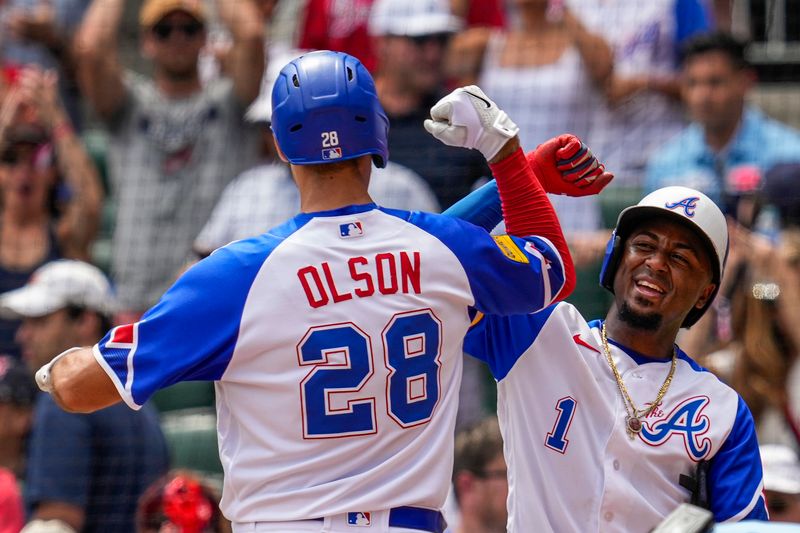 Jul 30, 2023; Cumberland, Georgia, USA; Atlanta Braves first baseman Matt Olson (28) reacts with second baseman Ozzie Albies (1)  after hitting a two run home run against the Milwaukee Brewers during the eighth inning at Truist Park. Mandatory Credit: Dale Zanine-USA TODAY Sports