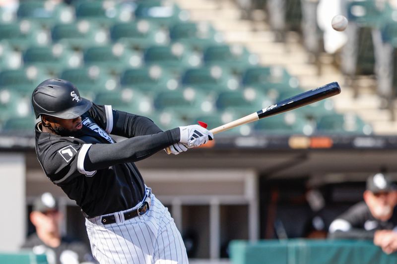 Apr 18, 2023; Chicago, Illinois, USA; Chicago White Sox center fielder Luis Robert Jr. (88) hits a two-run double against the Philadelphia Phillies during the third inning of game one of the doubleheader at Guaranteed Rate Field. Mandatory Credit: Kamil Krzaczynski-USA TODAY Sports