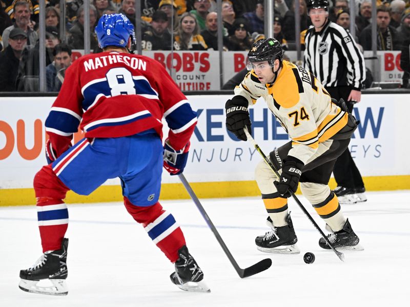 Jan 20, 2024; Boston, Massachusetts, USA; Boston Bruins left wing Jake DeBrusk (74) skates with the puck against Montreal Canadiens defenseman Mike Matheson (8) during the first period at the TD Garden. Mandatory Credit: Brian Fluharty-USA TODAY Sports