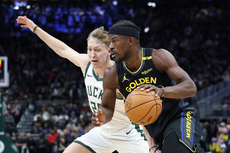 MILWAUKEE, WISCONSIN - FEBRUARY 10: Jimmy Butler #10 of the Golden State Warriors drives around AJ Green #20 of the Milwaukee Bucks during the first half of a game at Fiserv Forum on February 10, 2025 in Milwaukee, Wisconsin. NOTE TO USER: User expressly acknowledges and agrees that, by downloading and or using this photograph, User is consenting to the terms and conditions of the Getty Images License Agreement. (Photo by Stacy Revere/Getty Images)