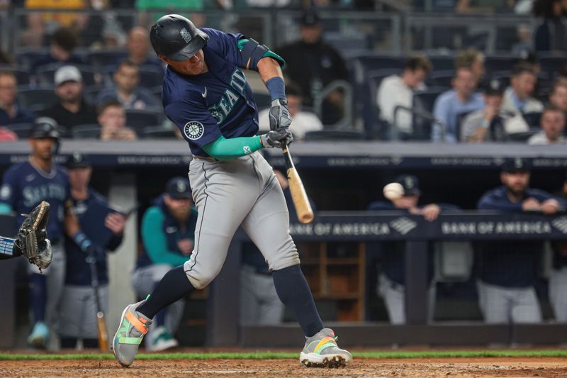 May 21, 2024; Bronx, New York, USA; Seattle Mariners shortstop Dylan Moore (25) hits an RBI single during the seventh inning against the New York Yankees at Yankee Stadium. Mandatory Credit: Vincent Carchietta-USA TODAY Sports