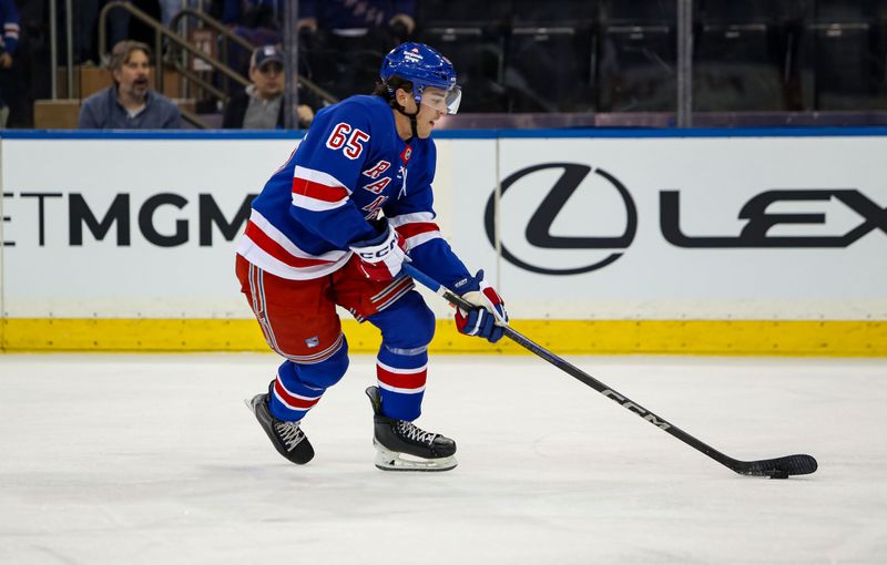 Sep 24, 2024; New York, New York, USA; New York Rangers left wing Brett Berard (65) skates with the puck against the New York Islanders during the first period at Madison Square Garden. Mandatory Credit: Danny Wild-Imagn Images