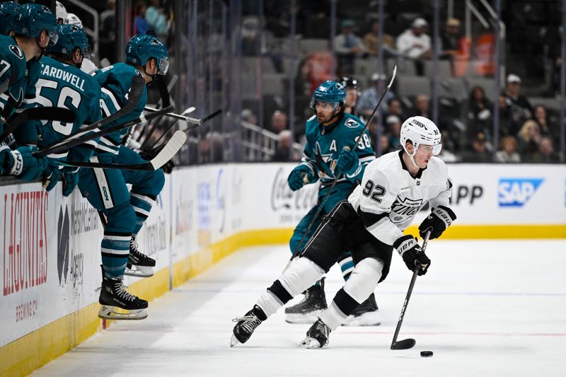 Oct 29, 2024; San Jose, California, USA; Los Angeles Kings defenseman Brandt Clarke (92) controls the puck against the San Jose Sharks in the second period at SAP Center at San Jose. Mandatory Credit: Eakin Howard-Imagn Images