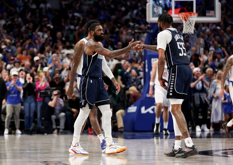 DALLAS, TEXAS - APRIL 28: Kyrie Irving #11 of the Dallas Mavericks is congratulated by teammate Derrick Jones Jr. #55 after making a three-point shot against the Los Angeles Clippers in the second half of game four of the Western Conference First Round Playoffs at American Airlines Center on April 28, 2024 in Dallas, Texas.  NOTE TO USER: User expressly acknowledges and agrees that, by downloading and or using this photograph, User is consenting to the terms and conditions of the Getty Images License Agreement. (Photo by Tim Warner/Getty Images)