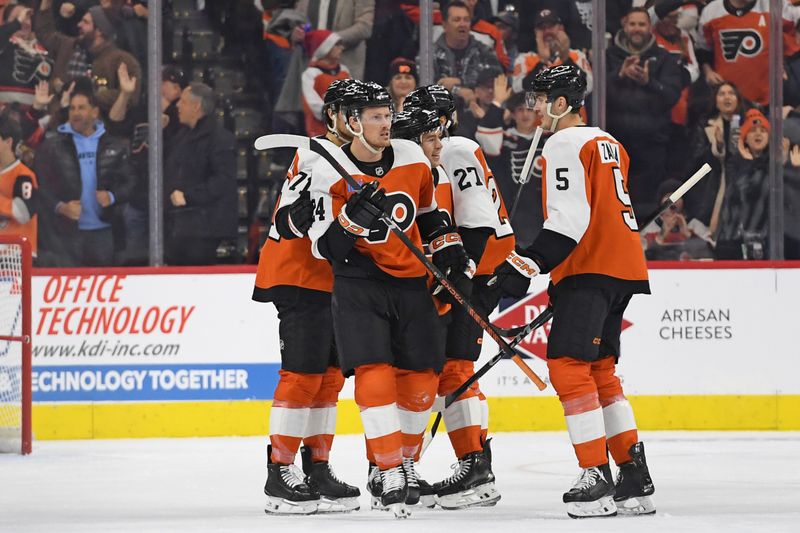 Dec 5, 2024; Philadelphia, Pennsylvania, USA; Philadelphia Flyers defenseman Nick Seeler (24) celebrates his goal with teammates against the Florida Panthers during the second period at Wells Fargo Center. Mandatory Credit: Eric Hartline-Imagn Images