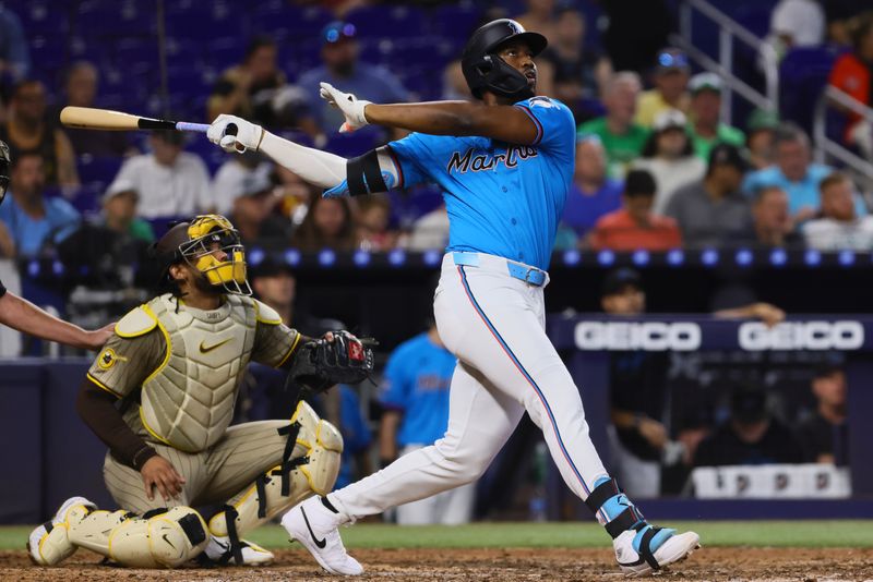 Aug 11, 2024; Miami, Florida, USA; Miami Marlins right fielder Jesus Sanchez (12) hits a two-run home run against the San Diego Padres during the seventh inning at loanDepot Park. Mandatory Credit: Sam Navarro-USA TODAY Sports