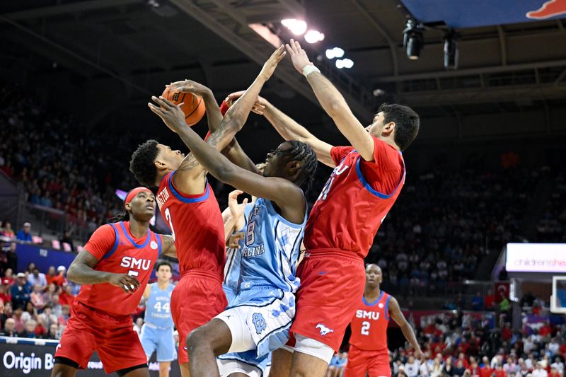 Jan 3, 2026; Dallas, Texas, USA; North Carolina Tar Heels forward Caleb Wilson (8) moves the ball to the basket past SMU Mustangs forward Corey Washington (3) and center Samet Yigitoglu (24) during the first half at Moody Coliseum. Mandatory Credit: Jerome Miron-Imagn Images