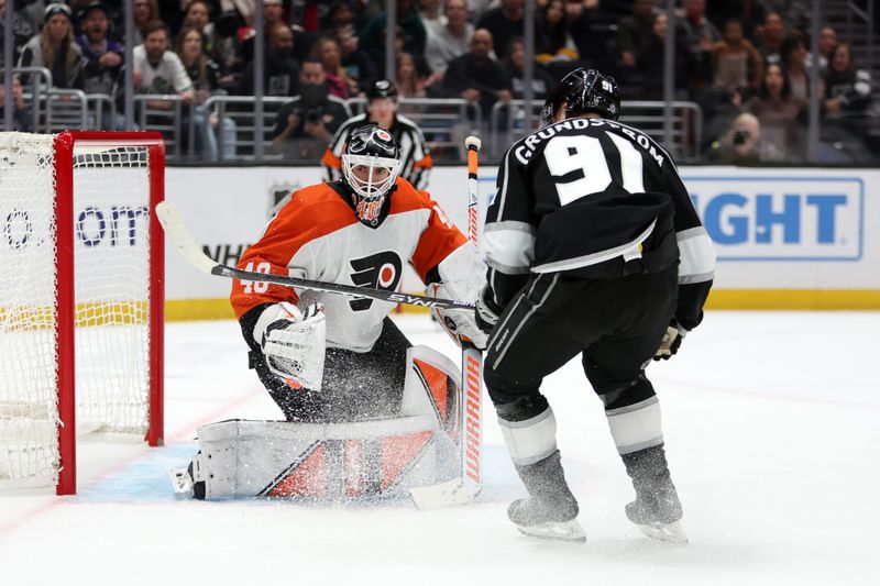 Nov 11, 2023; Los Angeles, California, USA;  Philadelphia Flyers goaltender Cal Petersen (40) defends the goal against Los Angeles Kings right wing Carl Grundstrom (91) during the second period at Crypto.com Arena. Mandatory Credit: Kiyoshi Mio-USA TODAY Sports