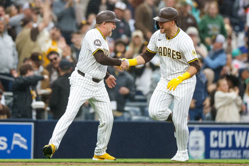 May 17, 2025; San Diego, California, USA; San Diego Padres first baseman Gavin Sheets (30) celebrates with San Diego Padres third base coach Tim Leiper (33) after hitting one run home run during the fourth inning against the Seattle Mariners at Petco Park. Mandatory Credit: David Frerker-Imagn Images