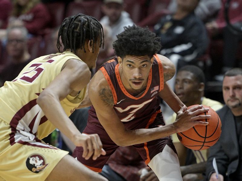 Jan 29, 2025; Tallahassee, Florida, USA; Virginia Tech Hokies guard Rodney Brown Jr. (4) eyes a pass during the first half against the Florida State Seminoles at Donald L. Tucker Center. Mandatory Credit: Melina Myers-Imagn Images